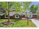 Beautiful home with lush lawn, mature trees, and brick accents at 6488 S Heritage E Pl, Centennial, CO 80111