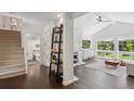 Bright living room with stone fireplace, vaulted ceiling, and large windows offering verdant views at 6488 S Heritage E Pl, Centennial, CO 80111