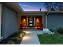 Inviting front entrance with a stylish door, bright lighting, and cozy seating, enhancing the home's appeal at 7065 E Caley Ave, Centennial, CO 80111