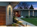Charming home featuring a well-manicured lawn, decorative lighting, and eye-catching curb appeal at 7065 E Caley Ave, Centennial, CO 80111