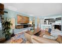 Relaxing living room boasts an open layout with a modern TV setup and adjacent kitchen at 1301 Speer Blvd # 207, Denver, CO 80204