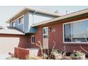 Charming brick home featuring a small manicured flower garden in front of the entrance at 5404 W Rowland Pl, Littleton, CO 80128