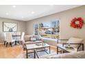 Cozy living room featuring a cow hide rug, sofa and a view of the front yard at 5404 W Rowland Pl, Littleton, CO 80128