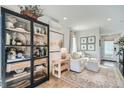 Bright living room with hardwood floors, neutral furniture, a stylish bookcase, and decorative accents creating a cozy atmosphere at 1301 Osceola St, Denver, CO 80204
