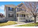 Well-maintained home features a cozy front porch, creating an inviting curb appeal at 9472 E 109Th Pl, Commerce City, CO 80640