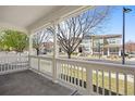 Relaxing covered front porch provides serene views of the neighborhood street at 9472 E 109Th Pl, Commerce City, CO 80640