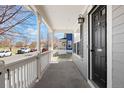 Covered front porch offers an outdoor living space with views of the neighborhood at 9472 E 109Th Pl, Commerce City, CO 80640
