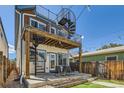 Enjoy outdoor living with a deck, spiral staircase, patio, and fenced yard, perfect for entertaining and relaxation at 3640 Lipan St, Denver, CO 80211