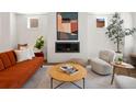 Stylish living room featuring a cozy fireplace, modern decor, and comfortable seating, ideal for relaxation and entertaining at 3640 Lipan St, Denver, CO 80211