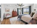 Serene main bedroom with a large window, dresser, and plush bedding, offering a relaxing retreat at 1601 Mariah Ln, Erie, CO 80516