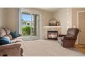 Inviting living room with a fireplace, comfortable furnishings, and a sliding glass door at 7212 S Blackhawk St # 1-103, Englewood, CO 80112
