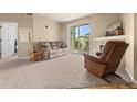 Comfortable living room with cozy seating, fireplace, and sliding glass doors to the outdoor at 7212 S Blackhawk St # 1-103, Englewood, CO 80112