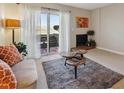 Bright living room with a sliding door to a patio, fireplace, creating an inviting indoor-outdoor living space at 519 Wright St # 106, Lakewood, CO 80228