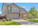 Attractive two-story home boasts an inviting front porch, landscaped yard, and a convenient two-car garage at 15955 E Otero Cir, Centennial, CO 80112