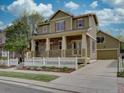 Inviting two-story home with a spacious front porch, attached garage, and manicured lawn at 5072 Meadow Mountain Dr, Broomfield, CO 80023