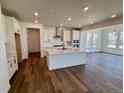 Bright, modern kitchen featuring white cabinetry, stainless steel appliances, and an island at 4609 Thistle Dr, Brighton, CO 80601