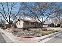 A ranch style home situated on a corner lot, adorned with mature trees at 2993 S Zenobia St, Denver, CO 80236