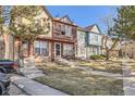 Street view showcasing the townhomes and their well-maintained front yards in a vibrant neighborhood at 12053 E Tennessee Ave, Aurora, CO 80012