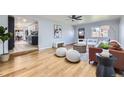 Inviting living room with hardwood floors, neutral paint, modern furniture, and seamlessly connected to kitchen area at 1280 S Quitman St, Denver, CO 80219