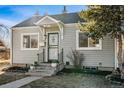 Charming home featuring a well-manicured lawn and welcoming front porch at 1665 Boston St, Aurora, CO 80010