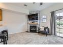 Cozy living room area featuring a stone fireplace and sliding glass door at 2139 Coronado Pkwy # B, Denver, CO 80229