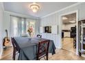 Well-lit dining room with hardwood floors and access to patio at 555 W Mansfield Ave, Englewood, CO 80110
