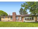 Single-Gathering home with brick chimney and front yard at 555 W Mansfield Ave, Englewood, CO 80110