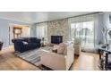 Inviting living room with stone fireplace and large windows at 555 W Mansfield Ave, Englewood, CO 80110