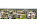 Wide aerial shot showcases a charming community, featuring well-maintained green spaces and convenient parking areas at 10211 Ura Ln # 1-202, Thornton, CO 80260