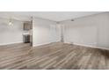 Spacious living room featuring modern flooring, neutral walls, and ample natural light at 10211 Ura Ln # 1-202, Thornton, CO 80260