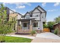 Stunning two-story home with modern gray exterior and landscaped front yard at 3908 Mariposa St, Denver, CO 80211