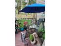 Inviting outdoor space featuring a table, chairs, umbrella, and beautiful decorative potted plants at 6504 Ralston Rd # A, Arvada, CO 80002