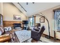 Comfortable living room with a fireplace, wood accent wall, ceiling fan and plush seating at 6504 Ralston Rd # A, Arvada, CO 80002
