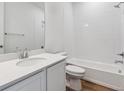 Clean bathroom features a shower over tub, white tiles and a modern vanity at 9072 Telluride Ct, Commerce City, CO 80022