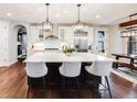 Modern kitchen features a large island with seating, pendant lighting, and stainless steel appliances at 10738 Braesheather Ct, Highlands Ranch, CO 80126