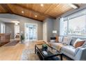 Inviting living room featuring a wood-beam ceiling, hardwood floors, and a comfortable seating area at 13020 Julian Ct, Broomfield, CO 80020