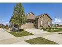 Single-Gathering home with stone facade, well-maintained lawn and professional landscaping at 16459 W 86Th Pl # B, Arvada, CO 80007