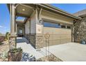 Attached two-car garage with painted wood door, adjacent to the covered front porch at 16459 W 86Th Pl # B, Arvada, CO 80007