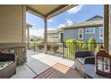 Comfortable patio area featuring comfortable chairs, a lantern, and views of the community at 16459 W 86Th Pl # B, Arvada, CO 80007