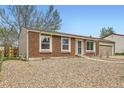 Cozy brick home with a low-maintenance front yard and convenient attached garage at 16755 E Union Ave, Aurora, CO 80015