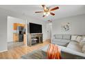 Open-concept layout connecting the living room to the kitchen with stainless steel appliances at 2103 Coronado N. Pkwy # D, Denver, CO 80229