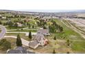 Scenic aerial view of a home nestled within a community with lush greenery and mountain views at 937 Caribou Dr, Monument, CO 80132