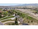 Expansive aerial view of a residential area with homes surrounded by nature and mountain vistas at 937 Caribou Dr, Monument, CO 80132