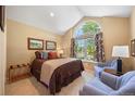 Cozy bedroom with a large arched window, comfortable seating, and neutral tones, creating a relaxing retreat at 5237 S Cody St, Littleton, CO 80123
