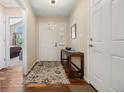 Bright foyer with hardwood floors, a console table, and a view into the living space, creating an inviting entrance at 5237 S Cody St, Littleton, CO 80123
