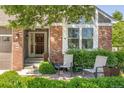 Inviting brick front porch with seating, lush greenery, and a well-maintained entrance, creating a welcoming curb appeal at 5237 S Cody St, Littleton, CO 80123