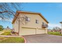 This home features a two-car garage and a small balcony on the second floor at 3355 S Flower St # 107, Lakewood, CO 80227