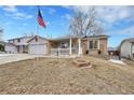 Inviting single-Gathering home featuring brick accents and a charming, partially-covered front porch at 3863 S Bahama St, Aurora, CO 80013