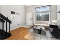 Cozy living room with hardwood floors, neutral paint, and bright, large windows at 1885 S Quebec Way # A28, Denver, CO 80231