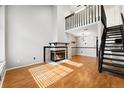 Bright living room with fireplace and updated staircase to the second-floor loft at 1885 S Quebec Way # A28, Denver, CO 80231